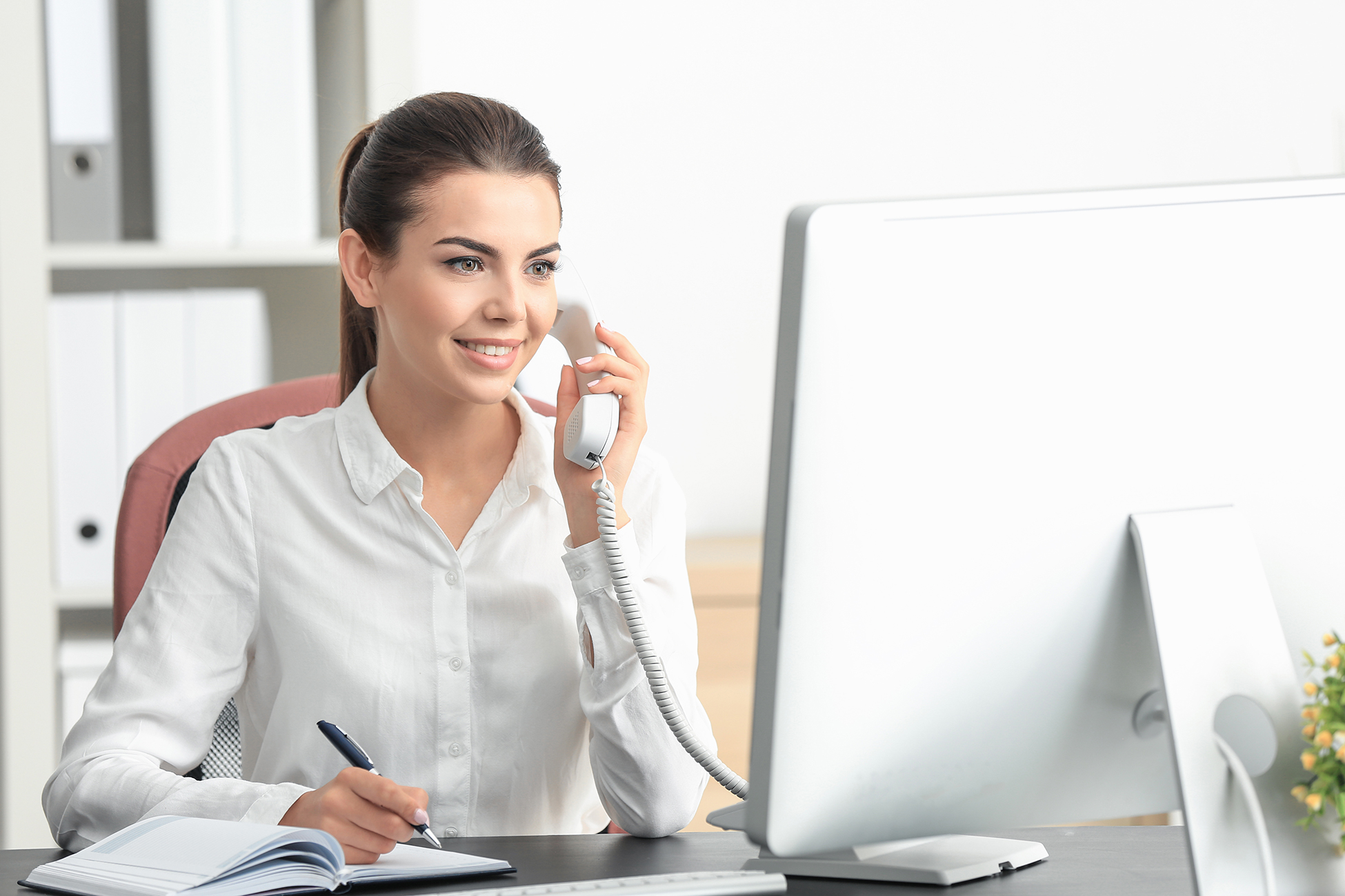 Woman Using a Telephone at Her Desk